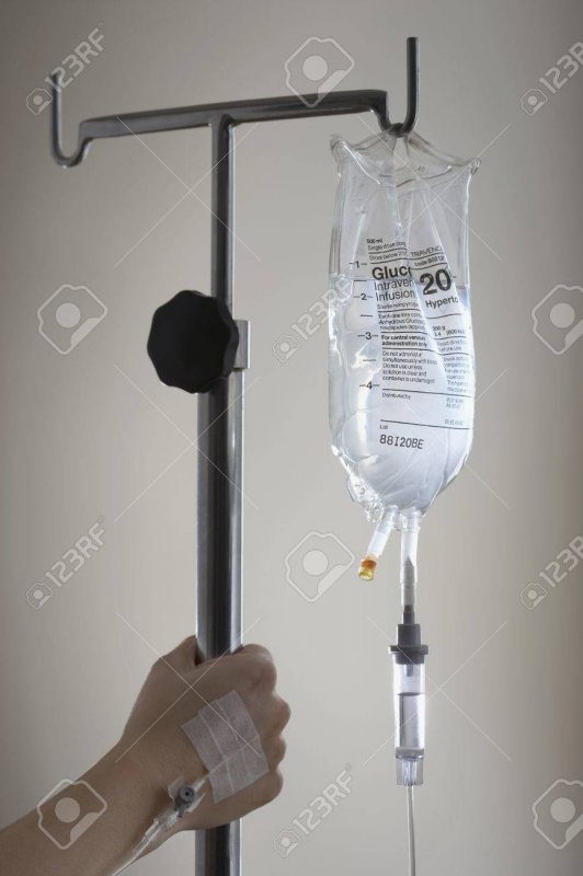 18885062-persons-hand-holding-stand-with-drip-bag.jpg